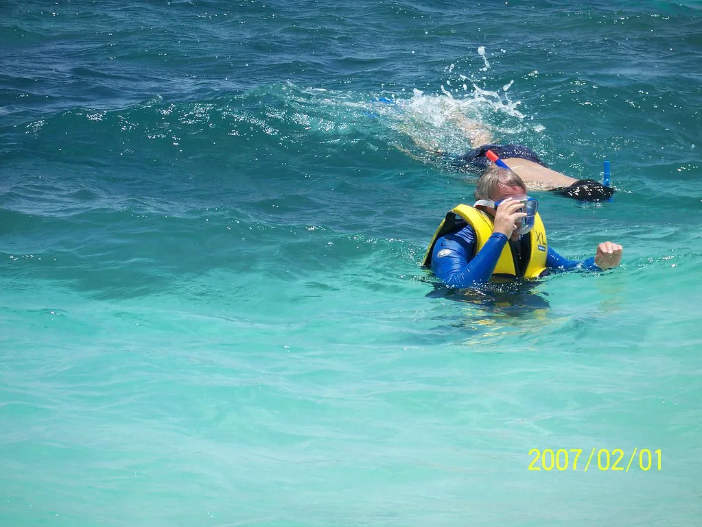 Snorkeler in a life vest in turquoise water