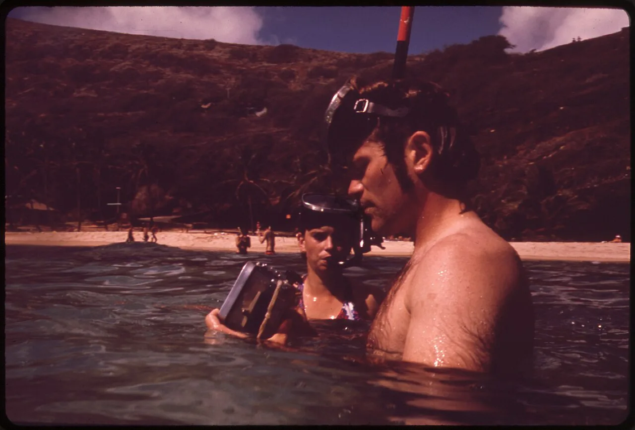 Snorkelers with an underwater camera in Hanauma Bay, Oahu