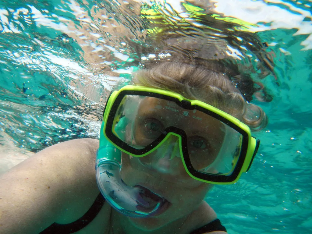 Close-up of a snorkeler in a yellow mask