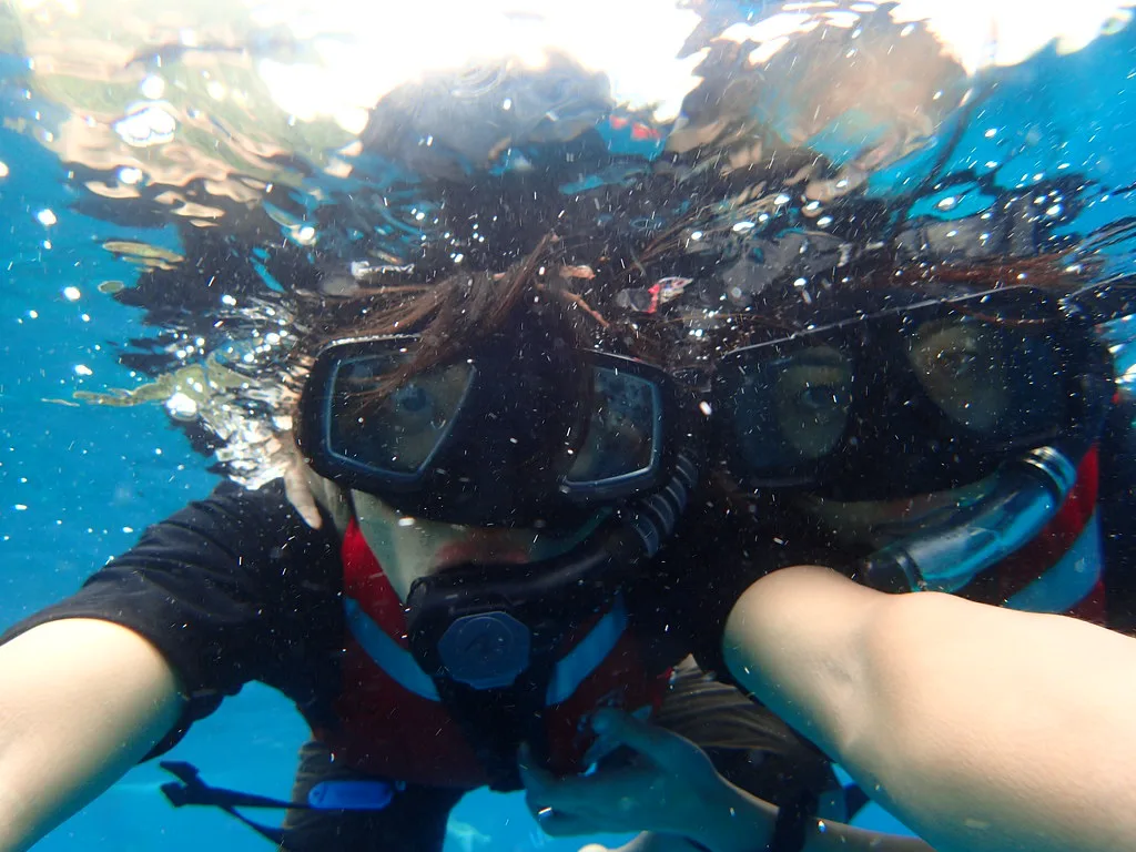 Two snorkelers in masks at Lang Tengah Island, Malaysia