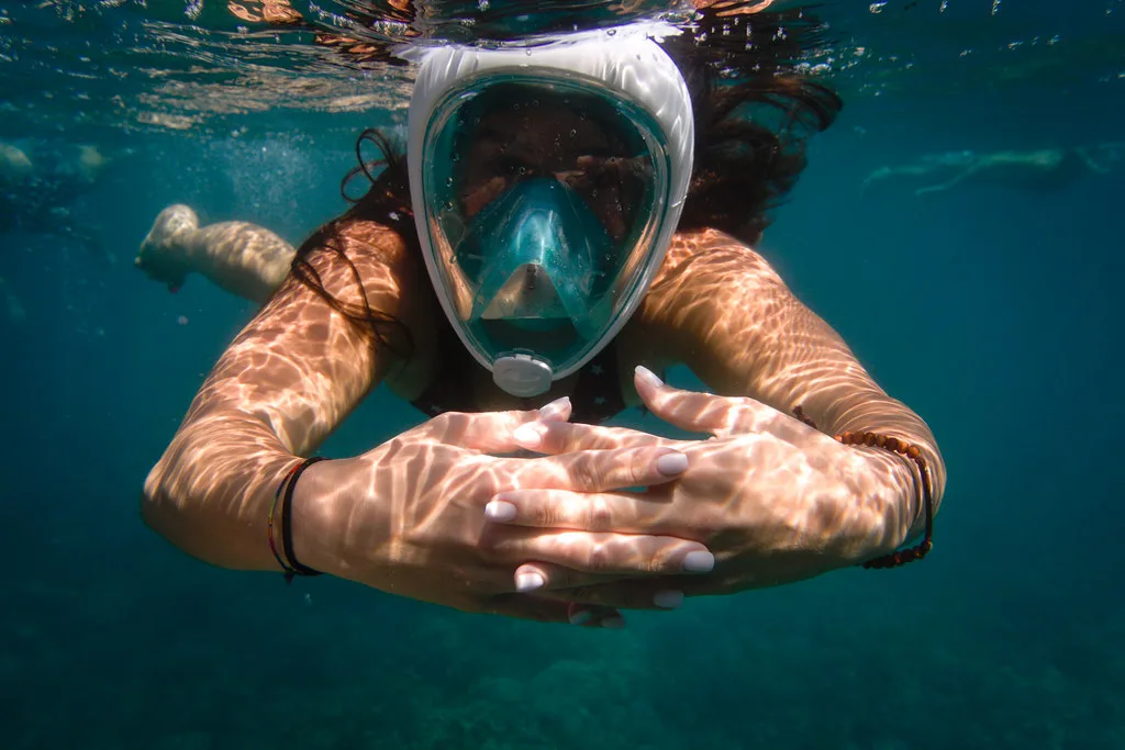 Snorkeler in a full-face mask underwater