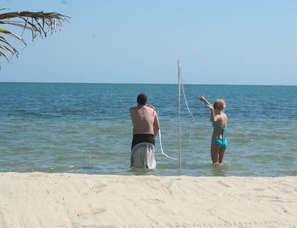 Bob & Stacey setting up volleyball net, Belize