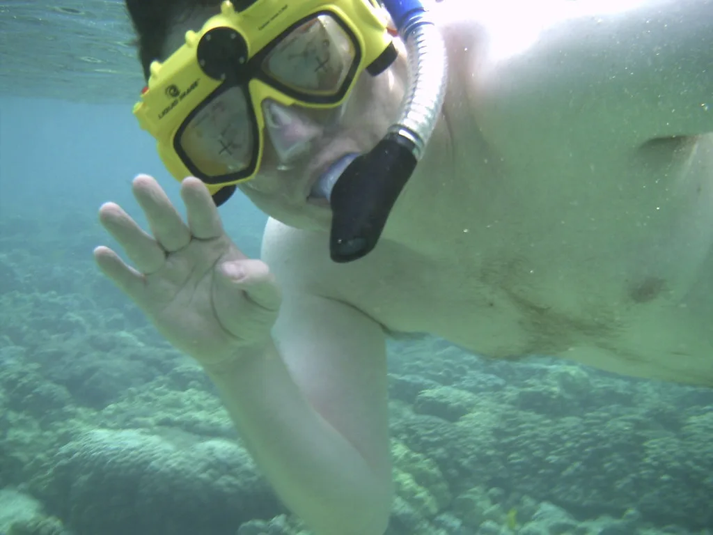 Snorkeler with a mask and a compact digital camera