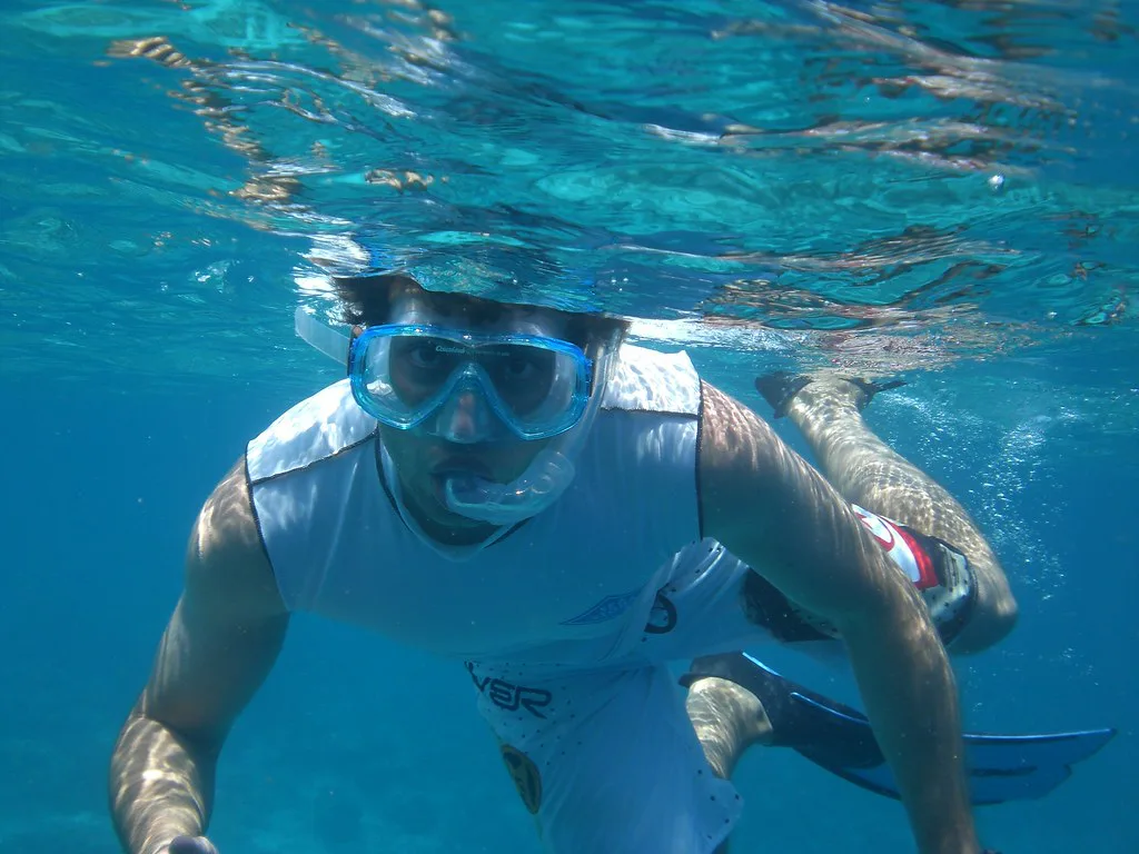 Snorkeler swimming underwater in a mask and snorkel